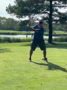 A Paul White Company employee takes a shot at the Camp Susan Curtis Golf Classic at the Woodlands Club in Falmouth, Maine